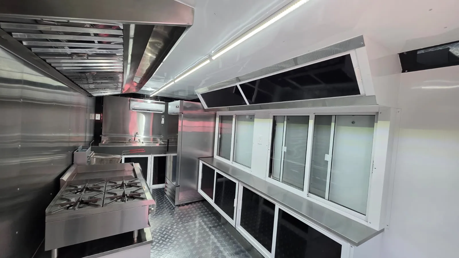 Carranza mobile kitchen cook line with hood, equipment and serving-side cabinetry